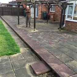 Patio area with coloured slabs before cleaning, Bixley Farm, Ipswich, Suffolk